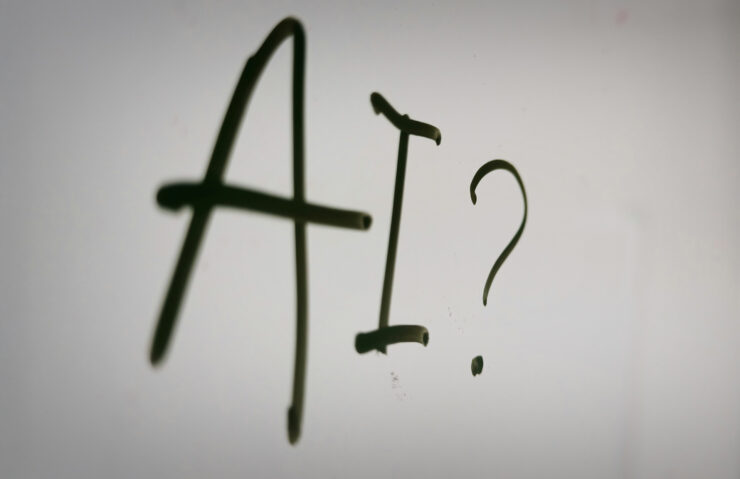 Whiteboard met daarop de letters AI en een vraagteken. Ter illustratie van de workshops over GenAI.
