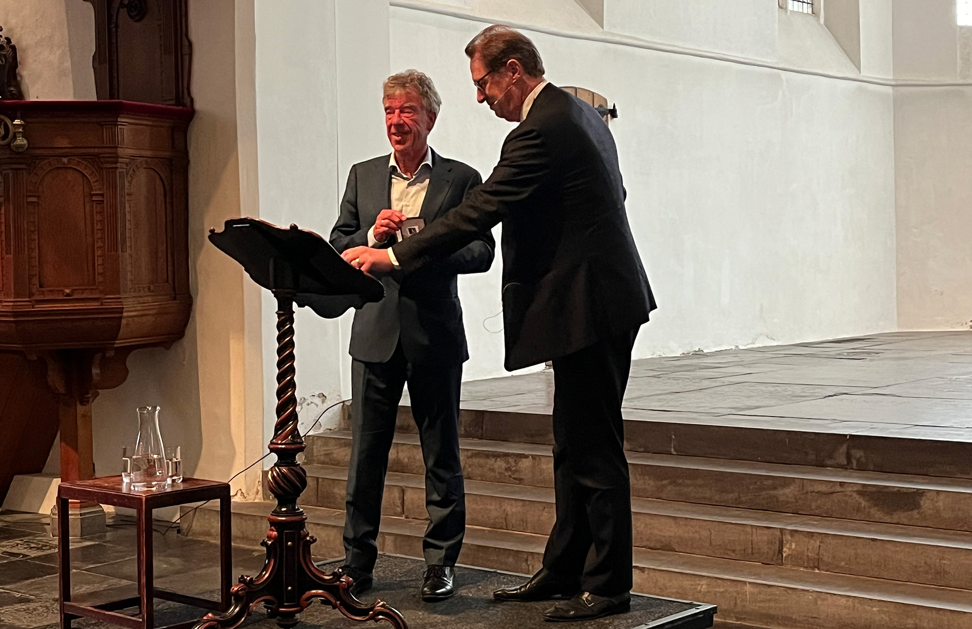 Herman Havekes en Rogier van der Sande op podium in kerk