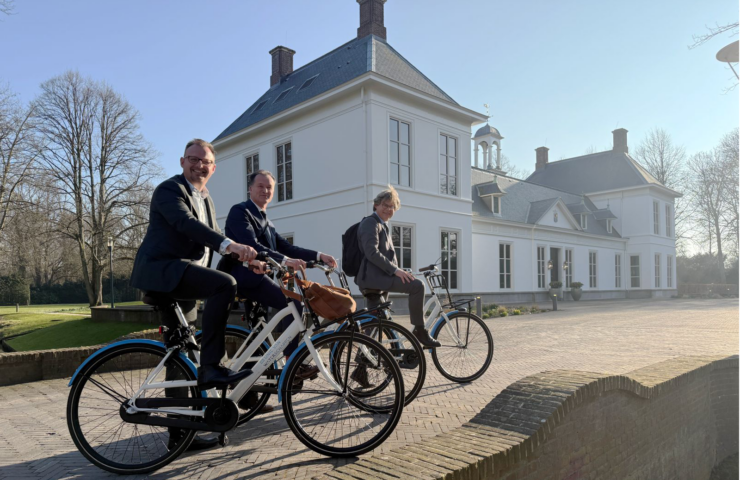 Erik den Hertog, Jeroen Haan en Meindert Smallenbroek op de fiets voor het Catshuis.